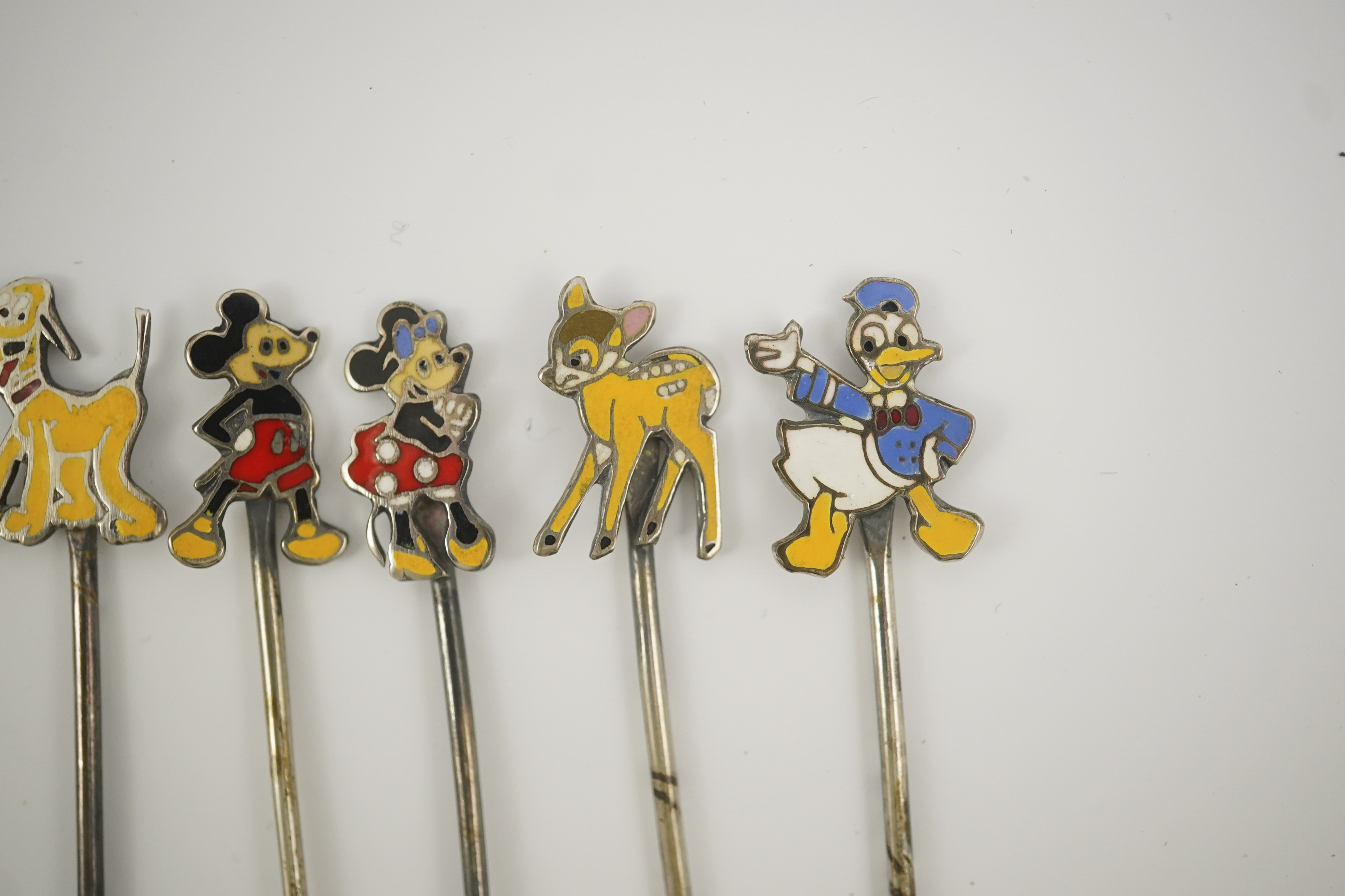 A cased set of six enamelled sterling Disney Character cocktail sticks